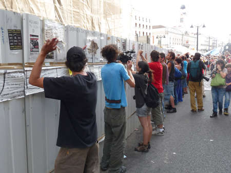 Madrid, Spain; June 11 2011. Protesters hitting a construction site barrier in protest. 15-M Outraged protests at Puerta del Sol in Madrid. Photography taken on June 11 2011 in Madrid, Spainのeditorial素材
