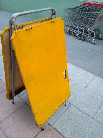 Old and worn out rural blank supermarket sign next to some shopping cartsの写真素材