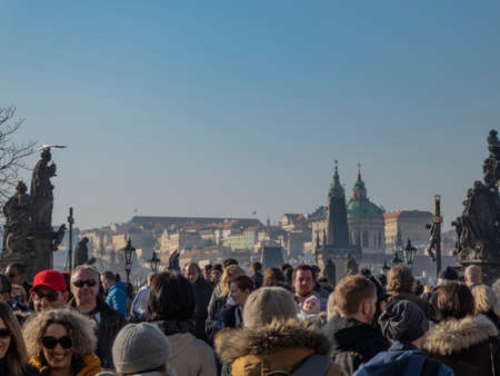 Prague, Czech Republic; February 16 2019. Charles IV Bridge in Prague full of walking people.