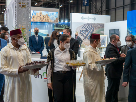 Madrid, Spain; January 19 2022. Attendees with dates, tea and traditional Arab sweets on trays, awaiting the arrival of the King and Queen of Spain in FITUR (International Tourism Trade Fair). Photography taken on January 19, 2022 in Madrid, Spain.のeditorial素材