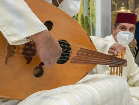 Madrid, Spain; January 19 2022. Close up of the hands of a Moroccan musician tuning an Arabic lute...