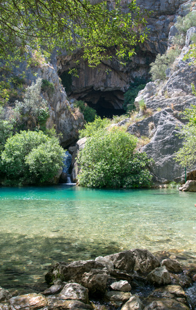 Beautiful crystal clear pool coming out of a cave near Ronda, Spainの写真素材