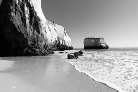 a black and white beach scene taken in Lagos, Portugalの写真素材