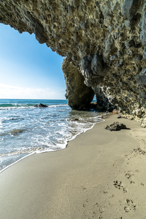 Rock cave at Monsul Beach in Almeria, Spainの写真素材