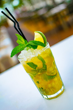 a chilled lime green mojito cocktail close upの写真素材