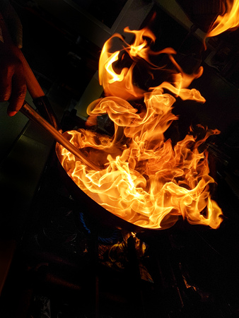 the silhouette of the flames whilst a chef flambÃ©ing in a local kitchen in Puerto Banus, Spainの写真素材