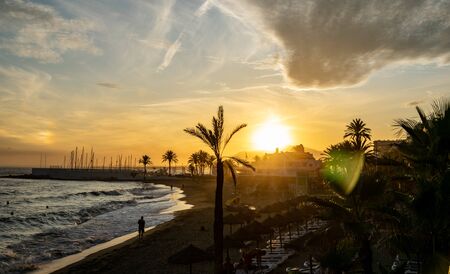 a sunset image along one of the many beaches found along the coast in Marbella, Spainの写真素材