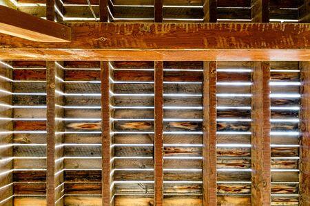 a upward view of wooden beam support pattern that holds up a houseの写真素材