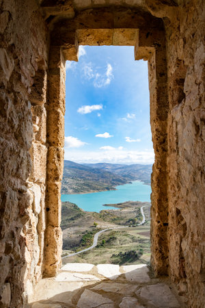 View through a stone window from the castle ruins of Zahara de la Sierraの写真素材