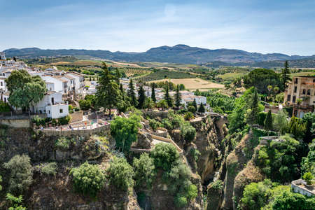 a landscape view of the hills and valleys surrounding the magical mountain town of Ronda in southern Spainの写真素材