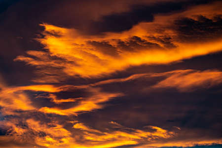 a landscape close up image of golden orange clouds during a sunset over the Mediterranean wallpaper...
