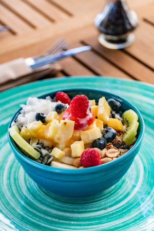 a close up portrait image of a fruit bowl on a wooden tableの写真素材