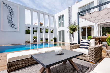 Beautiful swimming pool in luxury villa with white walls and balcony