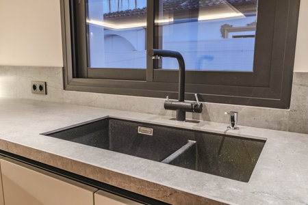 a close up image of a new kitchen sink installed in luxury mediterranean real estateの写真素材