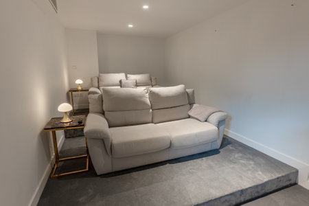 an image of a pair of leather sofas in private home cinema in mediterranean real estate
