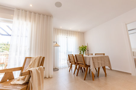 an image of a dining room area with speakers in the ceiling in mediterranean apartの写真素材