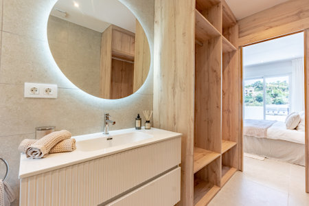 an image of a private bathroom with wooden shelving in the master bedroom of luxury mediterranean apartmentの写真素材