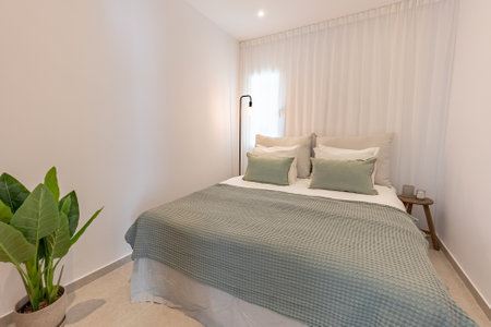 an image of a small guest bedroom with double bed in mediterranean holiday apartmentの写真素材