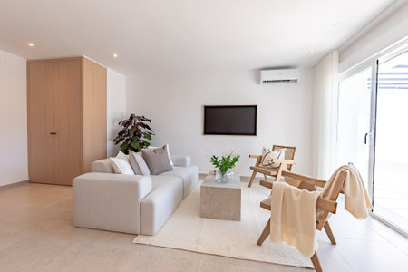 an image of a simple living room area with sofa and chairs in luxury mediterranean apartmentの写真素材