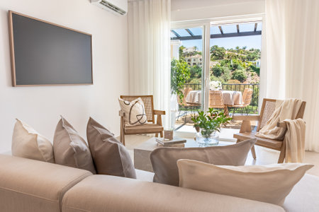 a close up image of a living room area leading to open balcony terrace in mediterranean holiday homeの写真素材