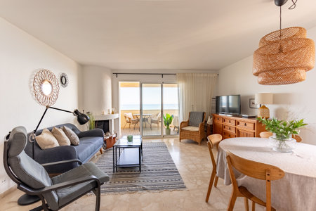 an open living room space with furniture and beachfront views in apartment in Marbellaの写真素材