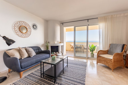 an image of a luxury mediterranean living room with fireplace and beachfront viewsの写真素材