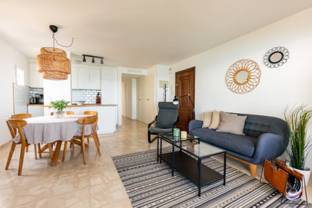 a traditional mediterranean living and dining room area in beachfront holiday apartmentの写真素材