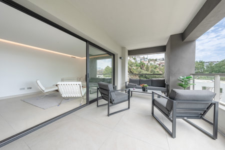 a close up image of an open balcony terrace leading to luxury mediterranean apartmentの写真素材