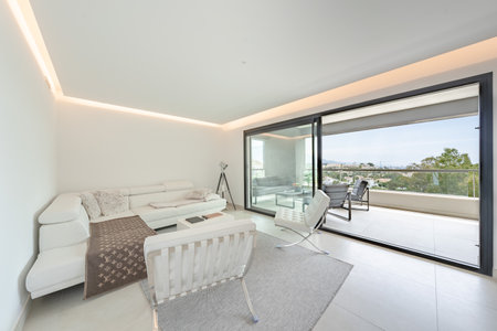 a luxury illuminated living room with leather chairs in mediterranean holiday homeの写真素材