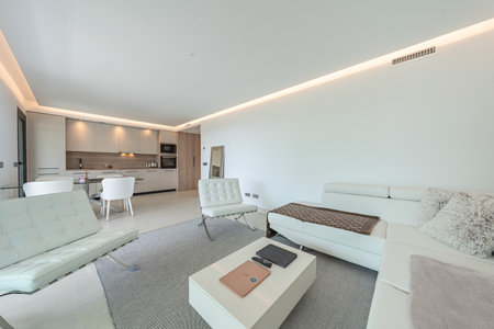 an image of open illuminated living room and kitchen area in mediterranean holiday homeの写真素材