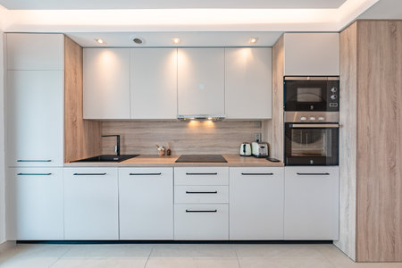 a close up image of a refurbished illuminated kitchen in mediterranean holiday homeの写真素材