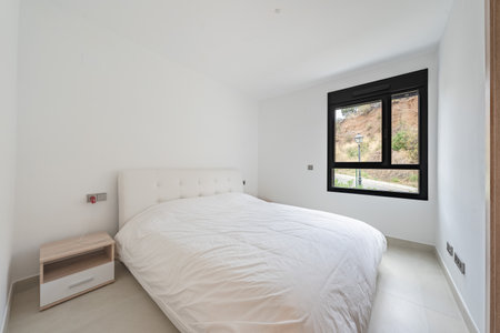 a bedroom with double bed and bedside table in holiday homeの写真素材