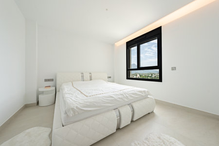 an image of a double bed with mountain views surrounding the town of Marbellaの写真素材