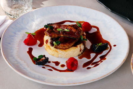pan seared duck foie gras with toasted brioche, berries and vanilla sauceの写真素材