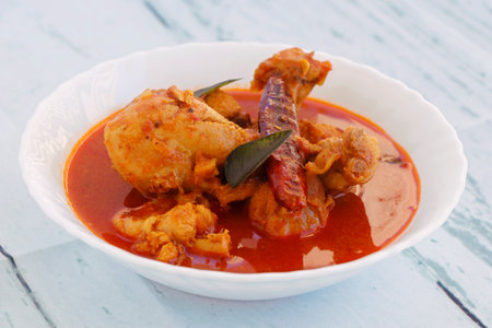Spicy Reddish Chicken Curry or masala served in a bowlの写真素材