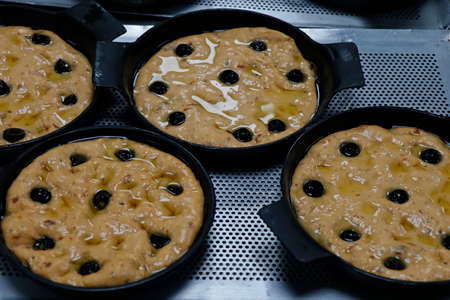 focaccia bread dough portions in a metal baking plateの写真素材