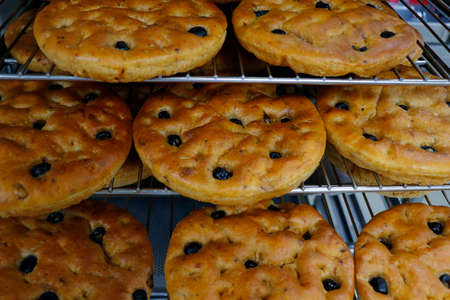 italian olive focaccia bread in baking traysの写真素材