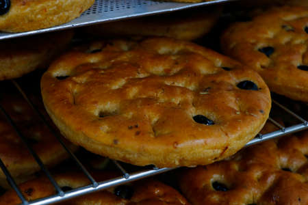 italian olive focaccia bread in baking traysの写真素材