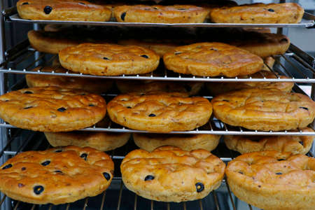 italian olive focaccia bread in baking traysの写真素材