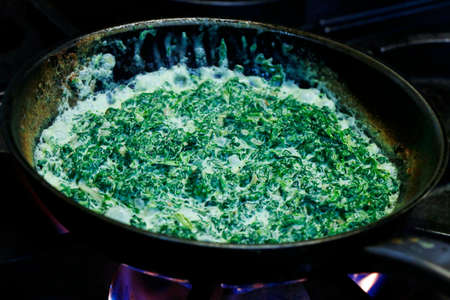 creamy saute spinach in a hot panの写真素材