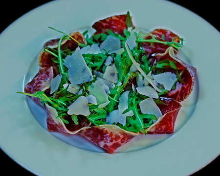 beef carpaccio ( thin slices of beef ) with roket leaves and parmeesan cheese, Italian starter foodの写真素材
