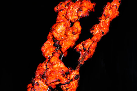 chicken tikka isolated with black background, indian foodの写真素材