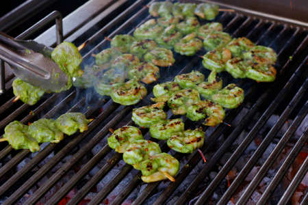 spice marinated prawns skewers on a charcol grillの写真素材