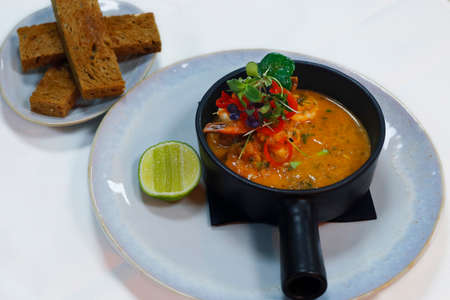 sauted king prawns in spicy tomato sauce with toasted breadの写真素材