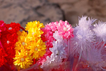 Colorful decorative artificial flowers crown in street stall for sell in kochi kerala