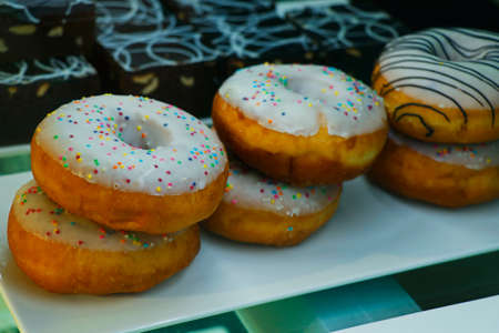 white Chocolate coated donut or doughnut with springlesの写真素材