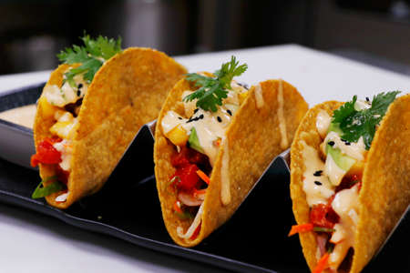 traditional Mexican dish taco,consisting of a small hand-sized corn or wheat tortilla topped with a fillingの写真素材