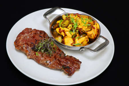 beef rib eye steak with potato wedges