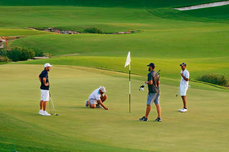 Dubai, United Arab Emirates - January 18, 2021 group of people playing golf in a green fieldのeditorial素材