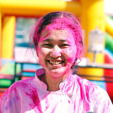 beautiful Indian lady With Colored Face celebrating festival of colors known as holiの写真素材